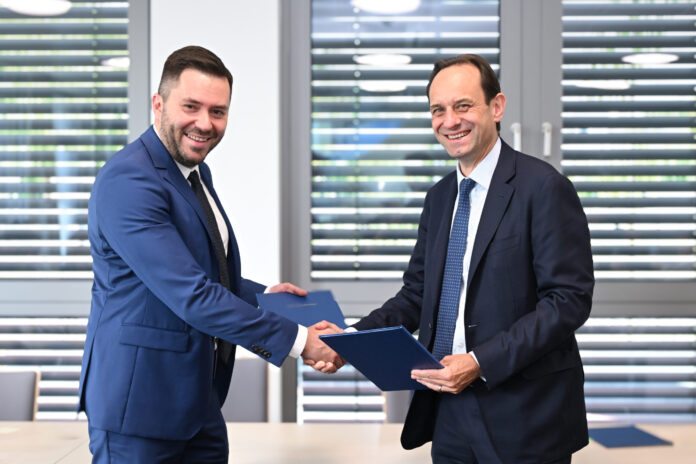 Ruslan Magomedov, chairman, NSSMC (L) and Mark Branson, president, BaFin (R)